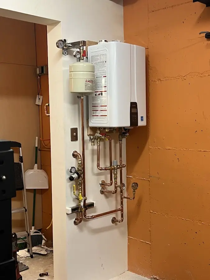 Plumbing technician inspecting water heater connections in Lauderdale-by-the-Sea